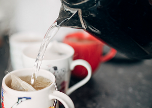 Energy saving image of kettle and mugs of tea 